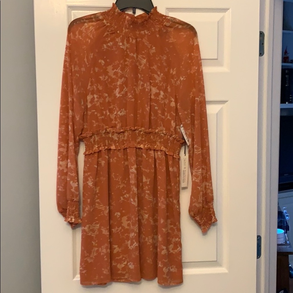 Long sleeve with smocking at neck and sleeve